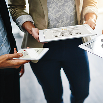 Guys Standing Holding Tablets