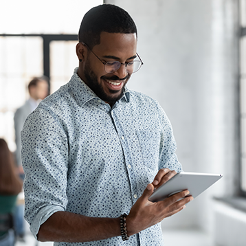 Man smiling browsing tablet