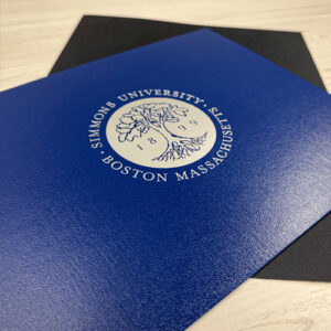 Blue custom diploma cover with Simmons University seal — Paradigm’s premium graduation certificate and diploma presentation solutions.