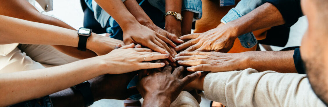 Teamwork concept with diverse hands joining together, symbolizing unity, cooperation, and collaboration
